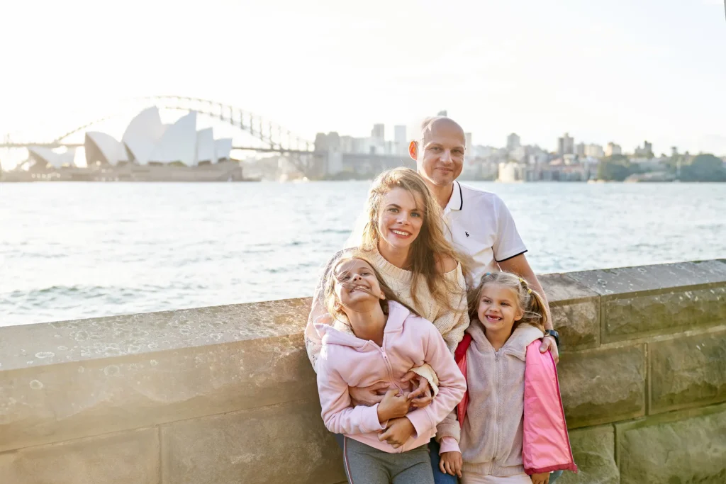 Happy parents and two daughters at Royal Botanic Garden with Opera House view