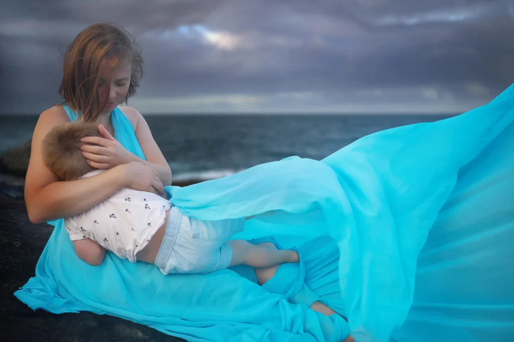 Mother and son breastfeeding moment in a flying dress on Northern Beaches