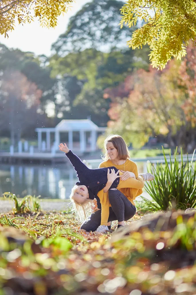 Fagan Park autumn family session with a happy girl in golden trees Galston