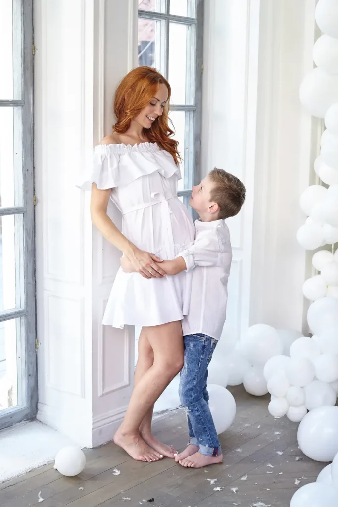 Mother and son standing face to face