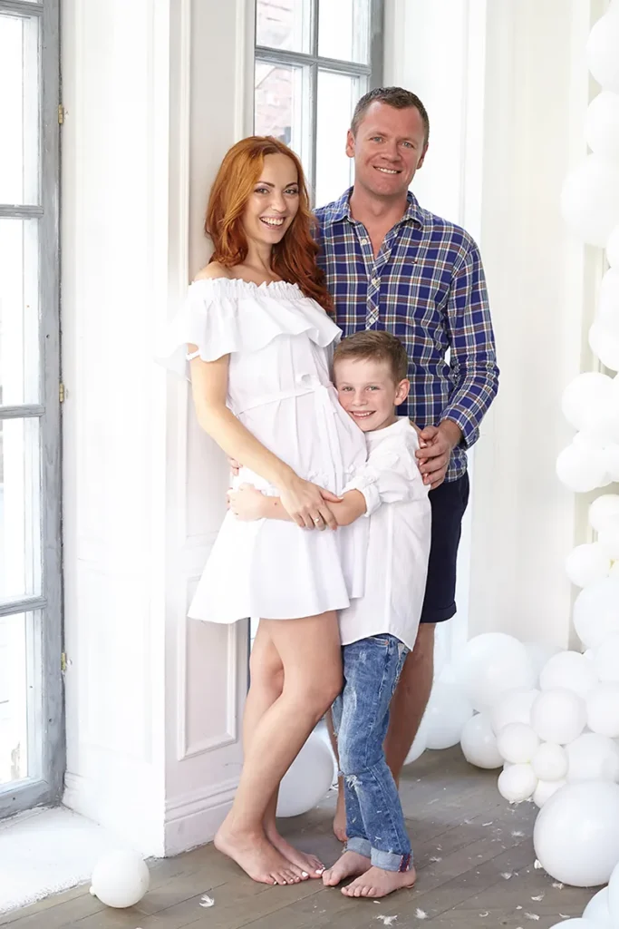 Parents and son standing together indoors