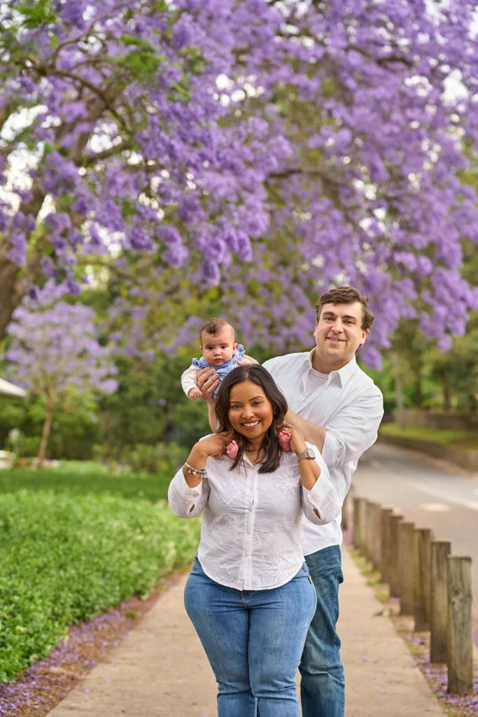 parents smiling with baby girl between them