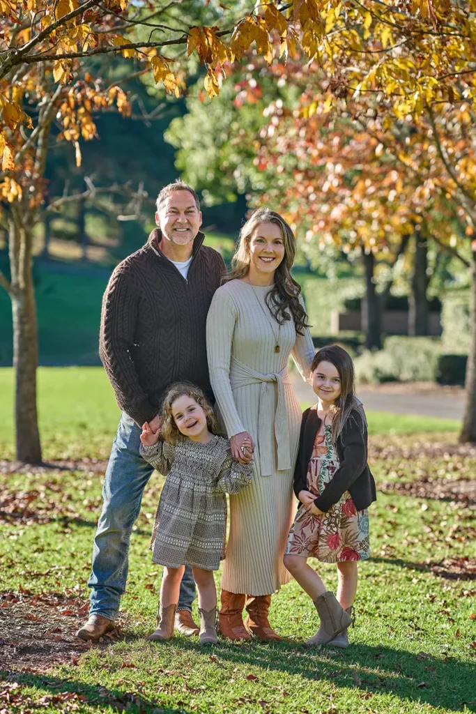 dad mum and two daughters smiling at Fagan Park Hornsby