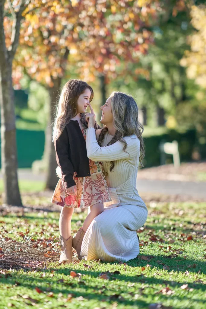 mother hugging her daughters close for Mother’s Day celebration