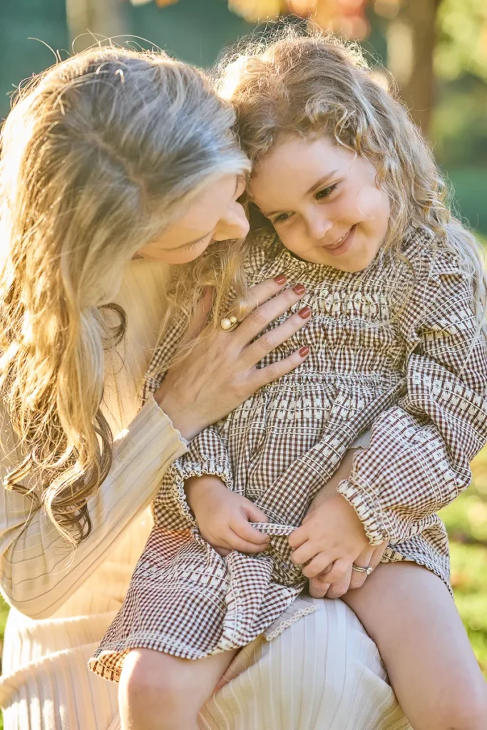 mum and younger daughter nose to nose smiling closely