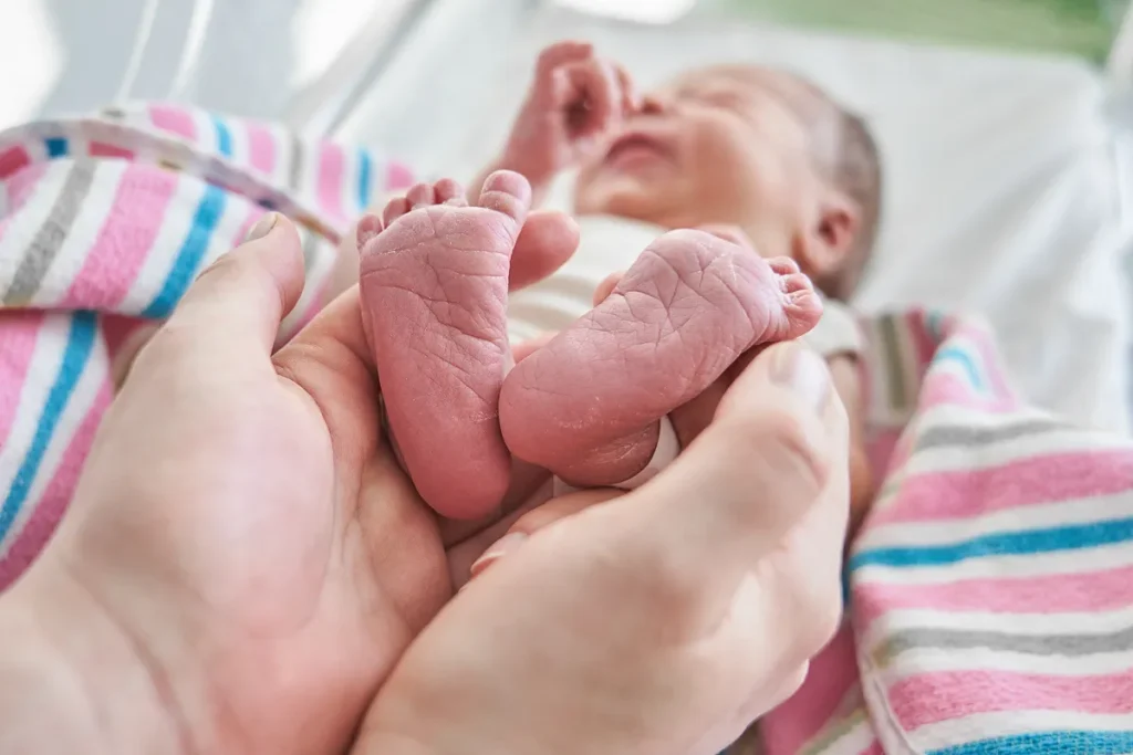 Close up of newborn feet wrapped in blanket