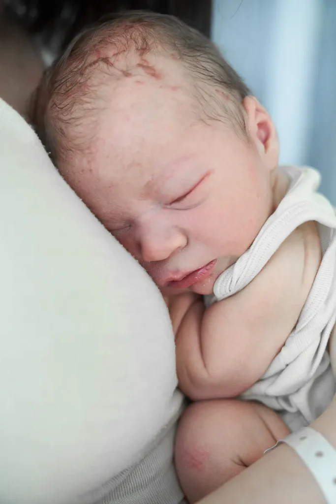 Sleeping newborn baby wrapped in soft blanket