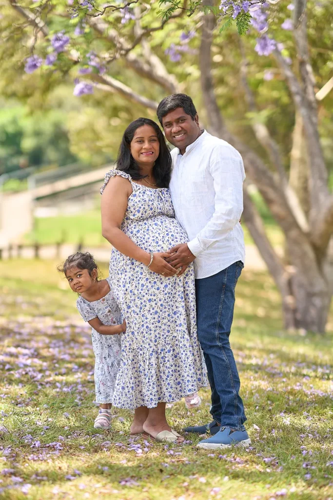 Mother father and daughter standing together at Parramatta Park
