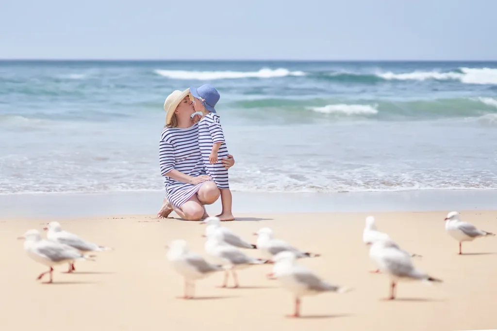Mother and daughter playing in sand on the Cronulla beach