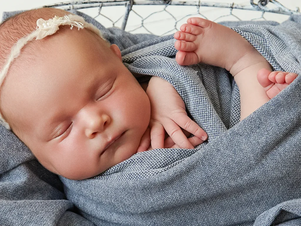 baby wrapped in grey sleeping in studio Hornsby