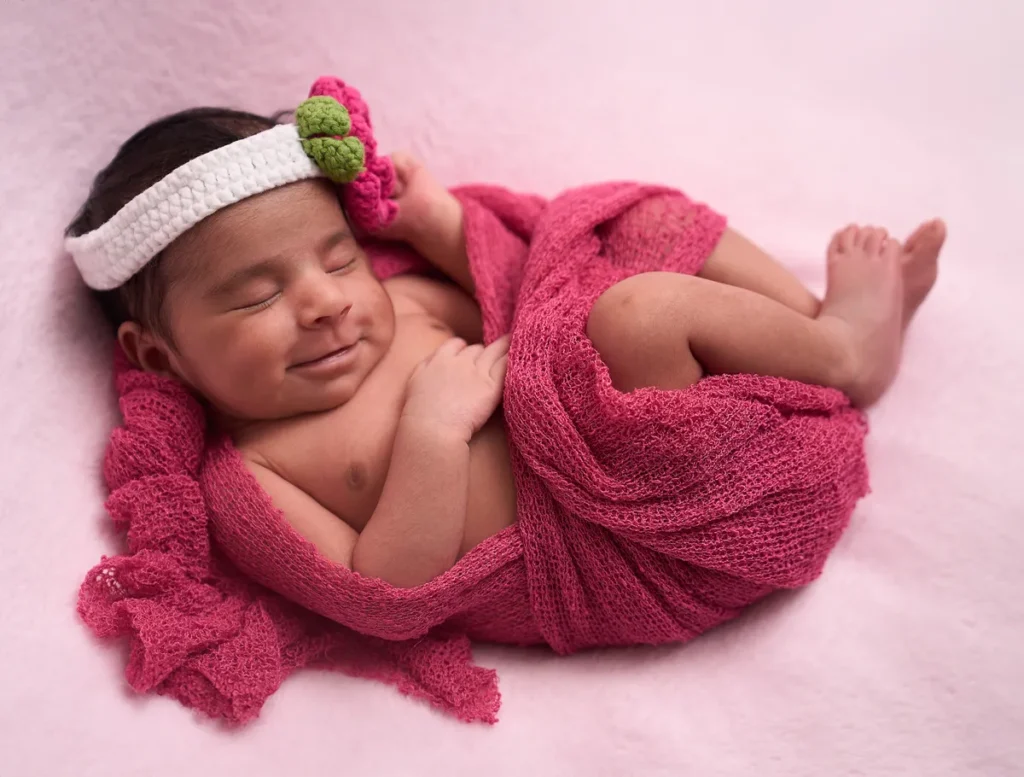 baby girl in pink headband wrapped in magenta in turramurra