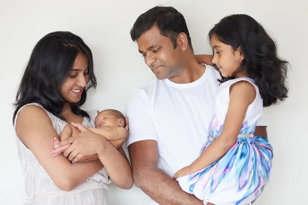 family of four with newborn and toddler girl