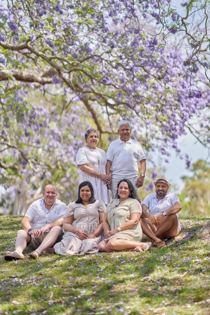Family seated in circle on grass