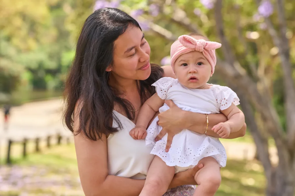 A mother holds her baby at Parramatta Park
