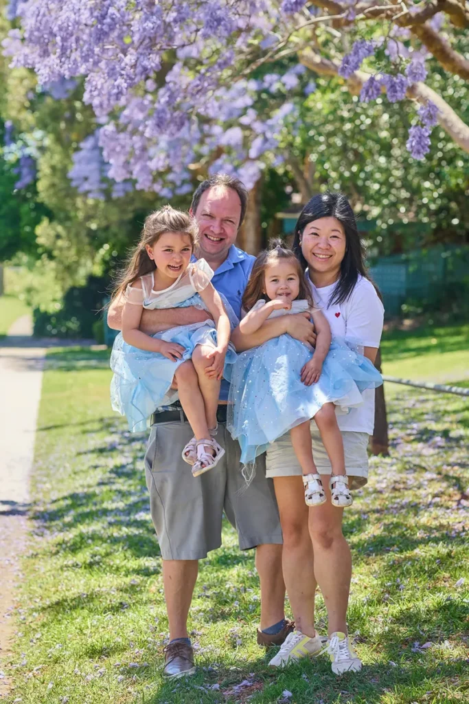 Family of four posing together