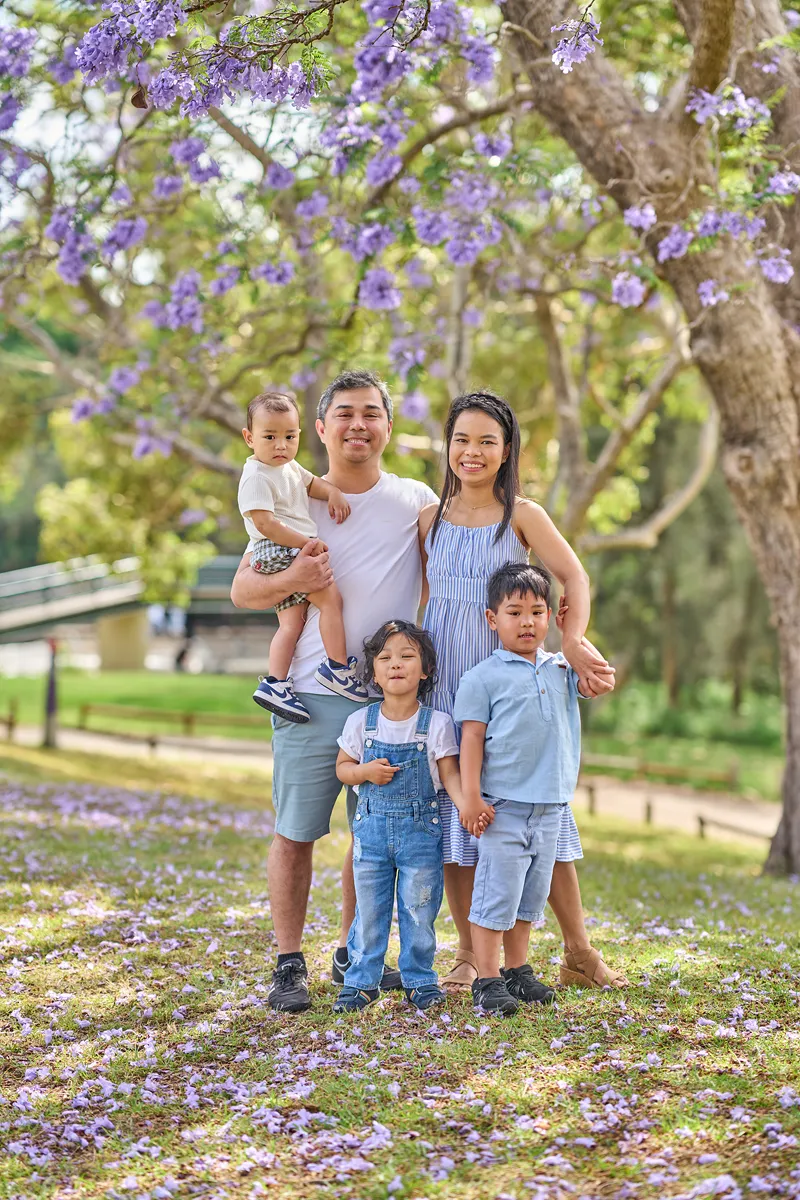 Parents and three sons standing at Parramatta Park