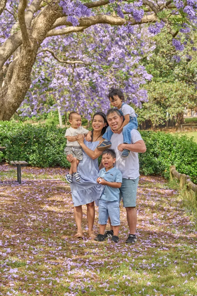 Parents and three sons among purple blossoms
