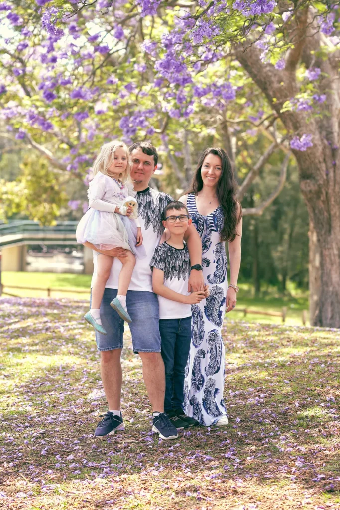 Parents and two children standing at Parramatta Park