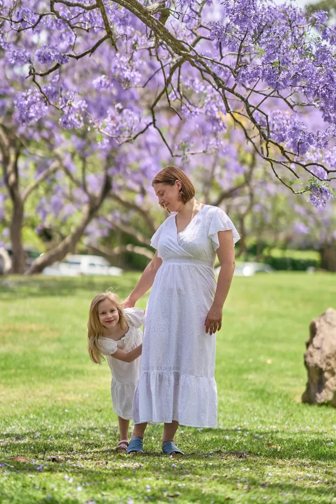 Mother and daughter under jacaranda at Hornsby