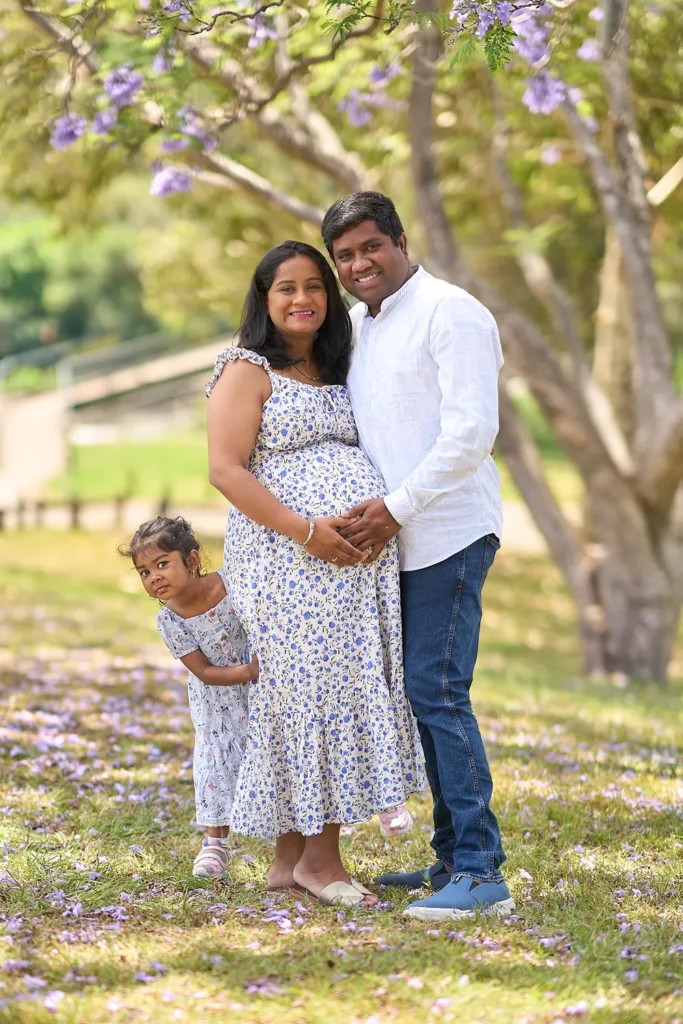 A family touches the belly of mum to be at Parramatta Park