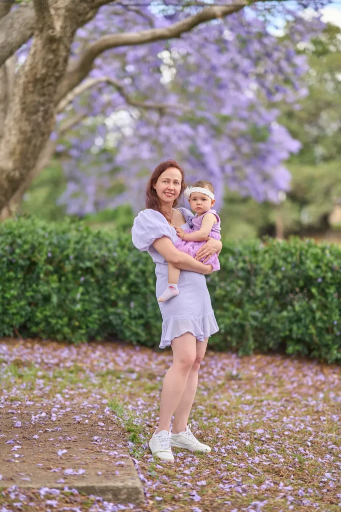 Mother holding daughter under tree at Parramatta Park
