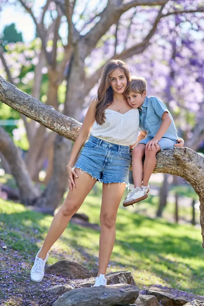 Mother and son on jacaranda branch in Hornsby