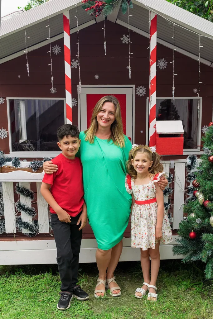 Mother stands with children outside