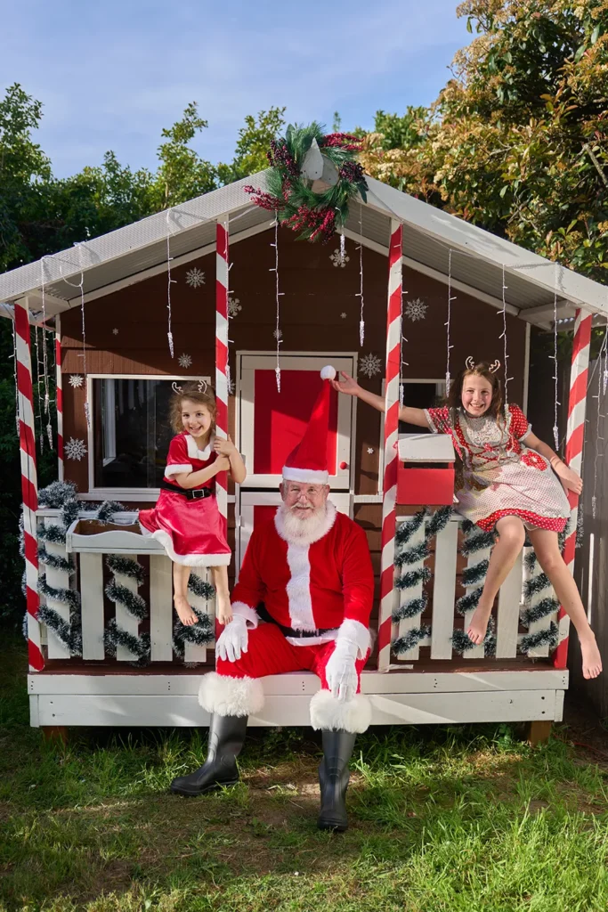 Santa and girl stand on porch