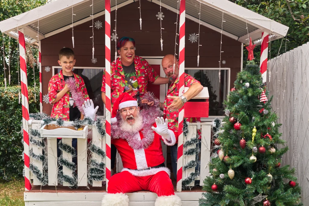 Family gathers with Santa near Christmas tree