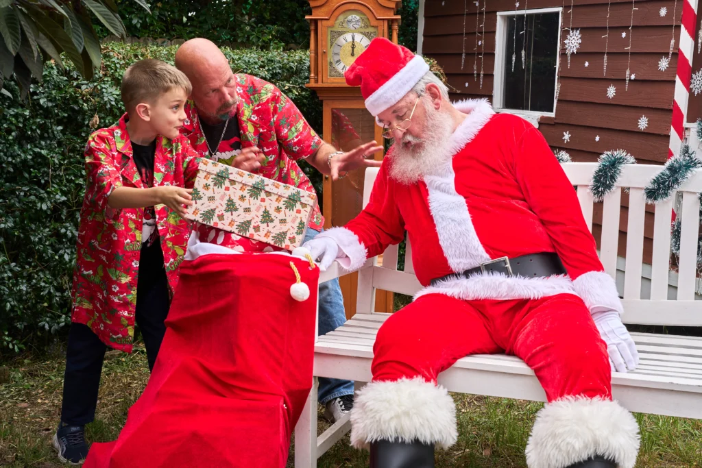 Child hands Santa a gift